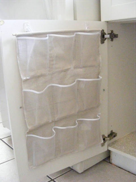 Cut up a plastic shoe holder and hang in bathroom cabinet for extra space