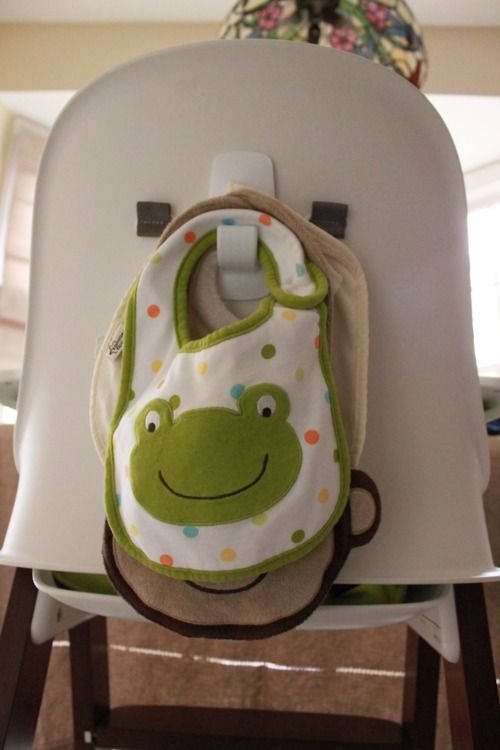 Use a command hook behind your high chair to hang bibs