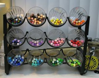 Use wine rack and plastic cups to store markers