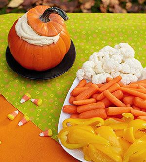 Arrange cauliflower, carrots, and yellow peppers in the shape of a candy corn
