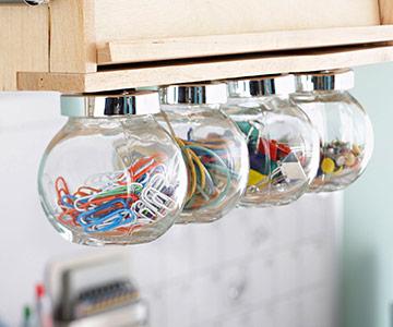 Use hanging glass bulbs for storing office supplies