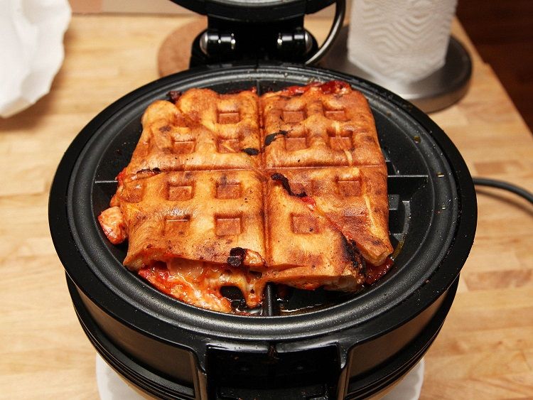 Cook leftover pizza with a waffle iron