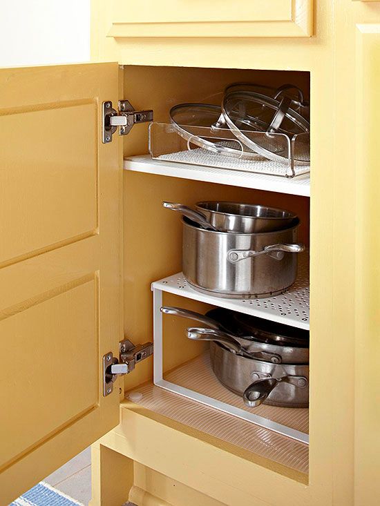 Add a tiered shelf to bring order to pots, pans, skillets, and lids