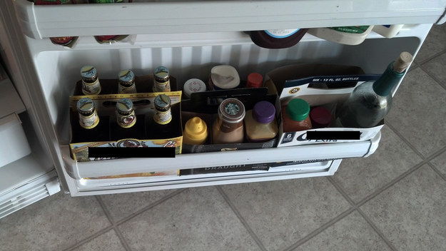 Use empty beer six pack containers to help organize your fridge door